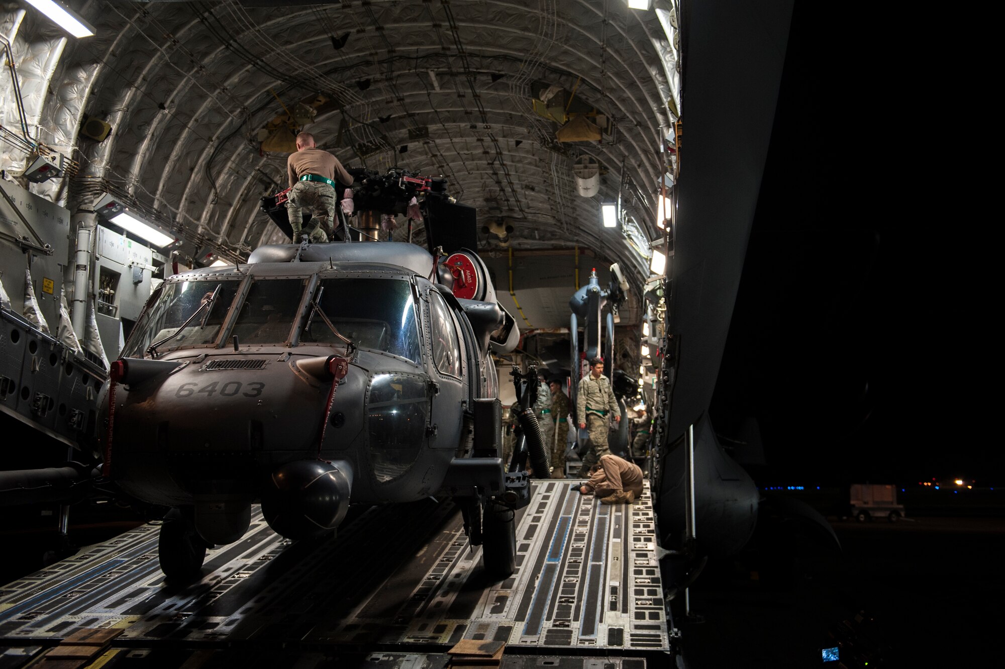 U.S. Air Force Airmen with the 33rd Helicopter Maintenance Unit load an HH-60 Pave Hawk into a C-17 Globemaster III, Jan 26, 2016, on the flight line at Kadena Air Base, Japan. The C-17 is capable of rapid strategic delivery of troops and all types of cargo to main operating bases or directly to forward bases in the deployment area. (U.S. Air Force photo by Airman 1st Class Nick Emerick)