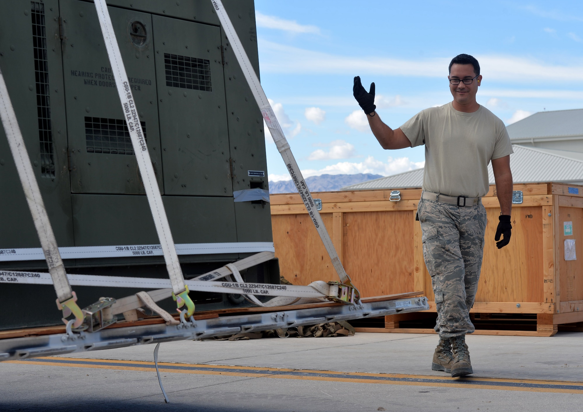 Tech. Sgt. Nicholas, 432nd Maintenance Squadron Aerospace Ground Equipment craftsman, loads pallets to be shipped to a deployment location Oct. 6, 2015, at Creech Air Force Base, Nevada. The 432nd AGE shop has recently achieved an above average passing rate of 95 percent, the highest that the shop has seen yet. The average passing rate for a typical AGE shop in the Air Force is about 85 percent. (U.S. Air Force photo by Senior Airman Christian Clausen/Released)