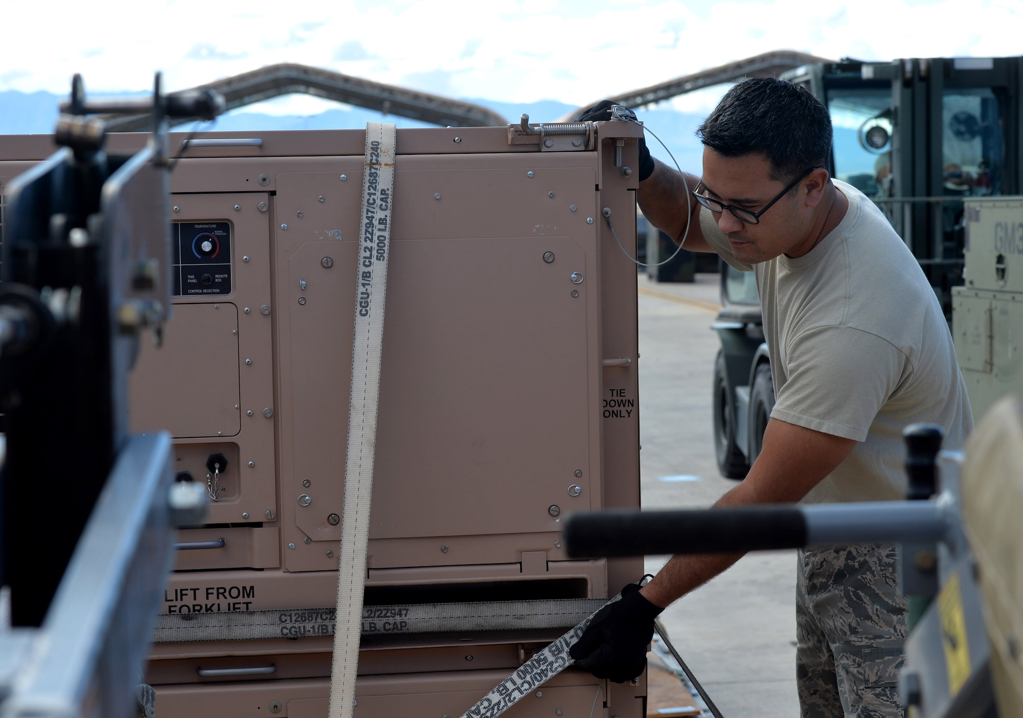 Tech. Sgt. Nicholas, 432nd Maintenance Squadron Aerospace Ground Equipment craftsman, loads pallets to be shipped to a deployment location Oct. 6, 2015, at Creech Air Force Base, Nevada. The equipment being sent will be received by maintainers overseas and used for upkeep on the remotely piloted aircraft. (U.S. Air Force photo by Senior Airman Christian Clausen/Released)