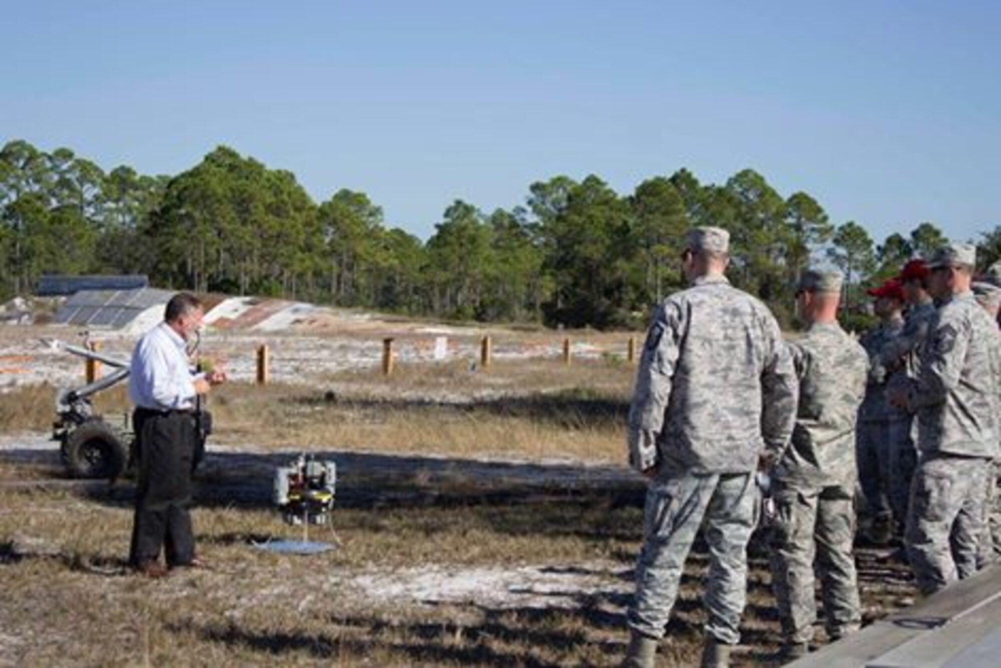 Workshop participants receive a briefing by Marshall Dutton, explosive ordnance disposal modernization program manager at the Air Force Civil Engineer Center, during the unexploded explosive ordnance mitigation workshop held Dec. 8, 2015, at the AFCEC Research Lab at Tyndall Air Force Base, Florida.