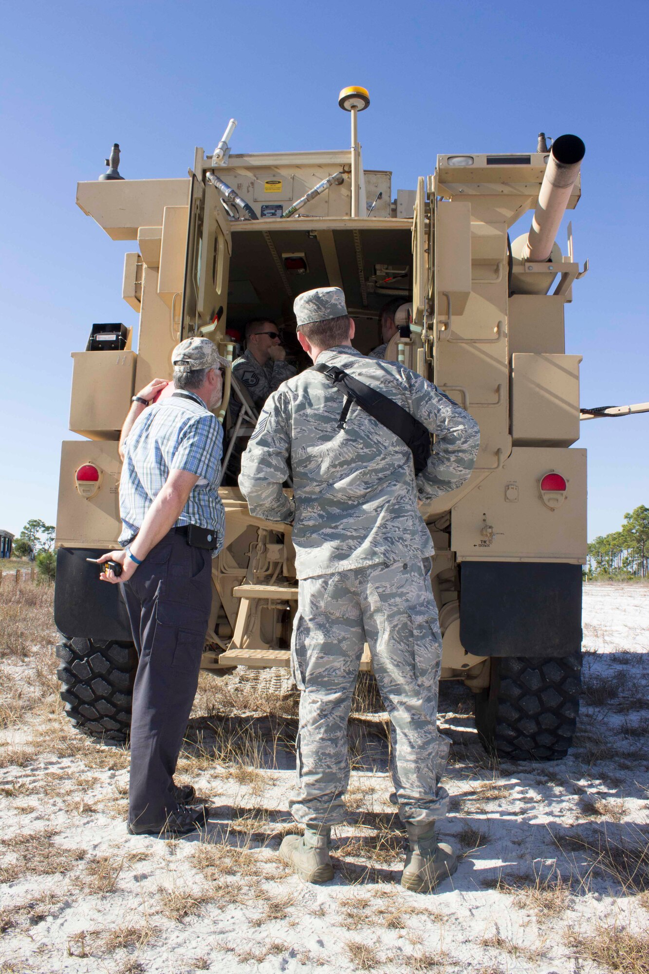 Workshop participants get an inside look at the recovery of airbases denied by ordnance, or RADBO vehicle, a ZEUS III laser integrated to a CAT1/A1 Mine Resistant Ambush Protected, during the unexploded explosive ordnance mitigation workshop held Dec. 8, 2015, at the Air Force Civil Engineer Center Research Lab at Tyndall Air Force Base, Florida. 