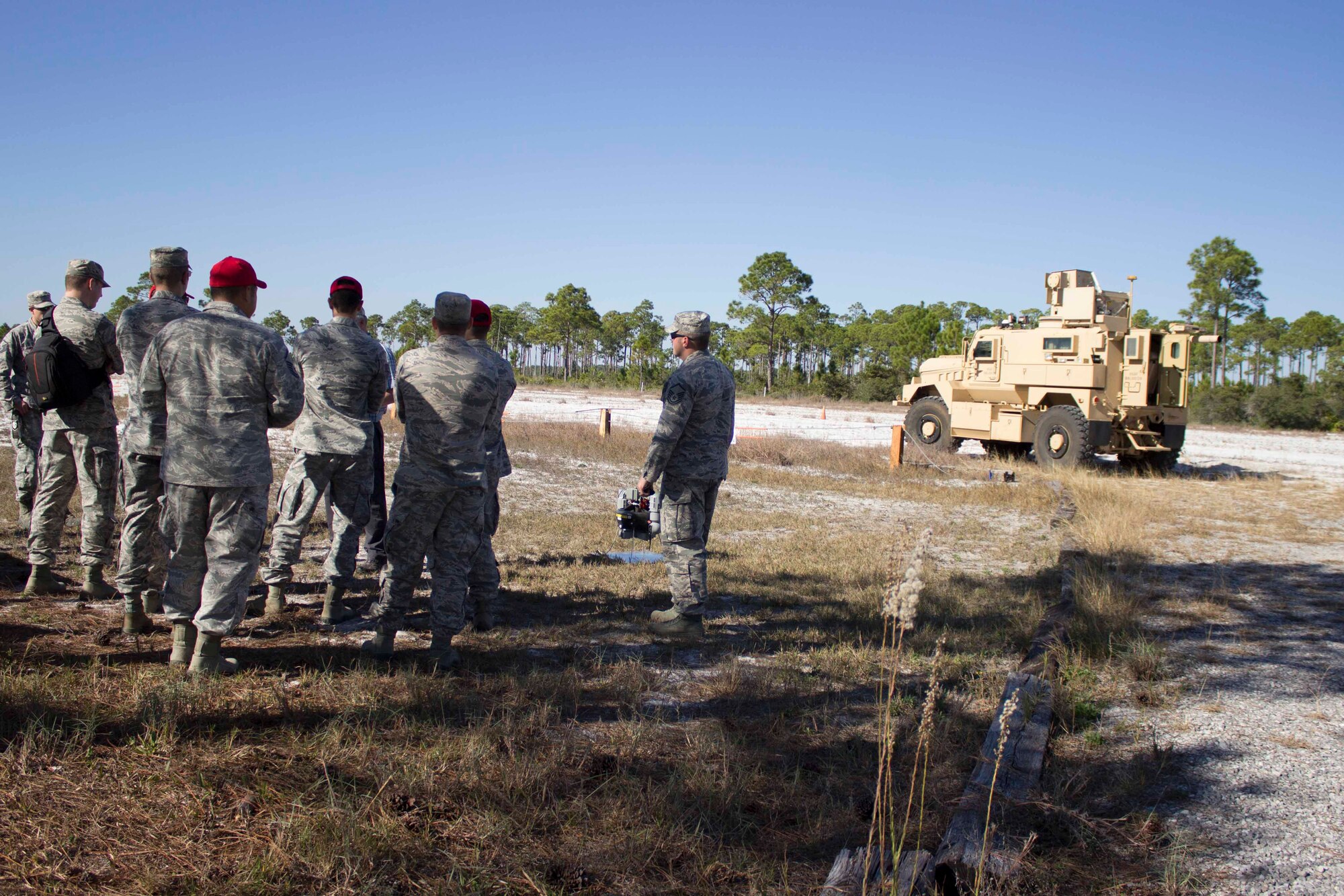 Workshop participants view a recovery of airbases denied by ordnance, or RADBO vehicle, a ZEUS III laser integrated to a CAT1/A1 mine resistant ambush protected, during the unexploded explosive ordnance mitigation workshop held Dec. 8, 2015, at the Air Force Civil Engineer Center Research Lab at Tyndall Air Force Base, Florida. 