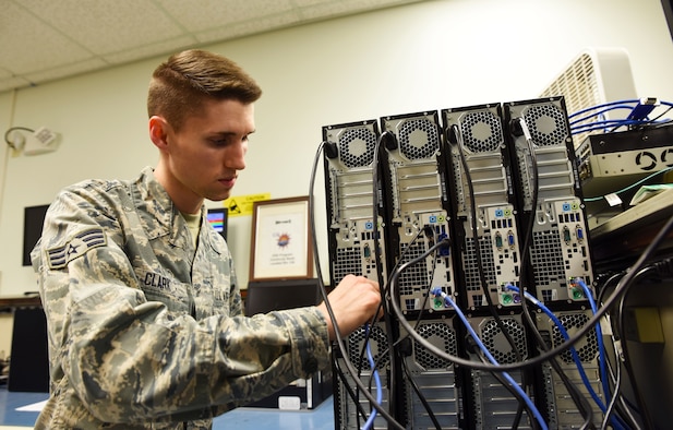 Senior Airman Travis Clark, 188th Communications Flight Focal Point, connects desktop computers to the network domain at Ebbing Air National Guard Base, Fort Smith, Ark., Dec. 6, 2015. Clark has been selected as the Flying Razorback Spotlight for February 2016. (U.S. Air National Guard photo by Senior Airman Cody Martin/Released)