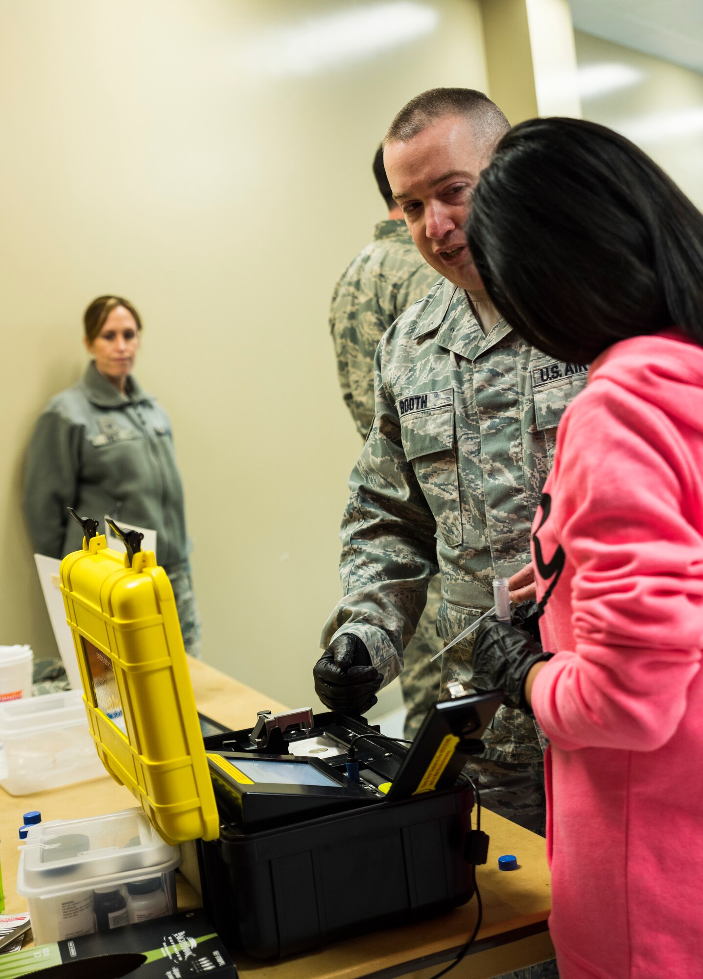 Tech. Sgt. Timothy Booth, 188th Medical Group bioenvironmental engineer, shows a cadet of the Northside High School junior reserve officer training corps program how to use the Hazmat ID 360 command system Jan. 25, 2016, during their visit of the 188th Wing at Ebbing Air National Guard Base, Fort Smith Ark. The cadets of the Northside junior reserve officer training corps (JROTC) program came to the 188th to learn about careers in the Air National Guard. Bioenviornmental engineers use the HAZMAT ID command system to identify materials by reflections of light. (U.S. Air National Guard photo by Senior Airman Cody Martin/Released)