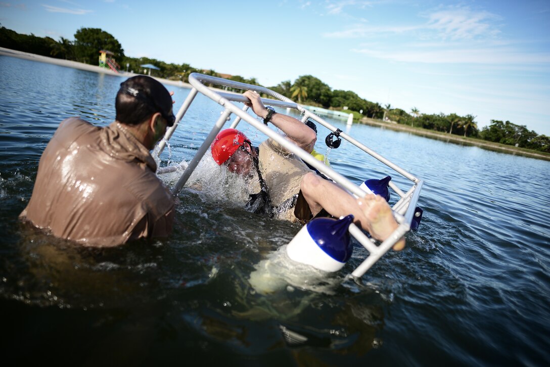 HOMESTEAD, FL - Members of the 101st Rescue Squadron conduct Water Survival Training (WST) near Homestead Air reserve Base on January 20, 2016. Aircrew members must conduct multiple dunks in the Shallow Water Egress Trainer in a four foot, man-made pool and demonstrate an ability to exit an aircraft while upside down and completely submerged under water. 

(US Air National Guard / Staff Sgt. Christopher S Muncy / released)