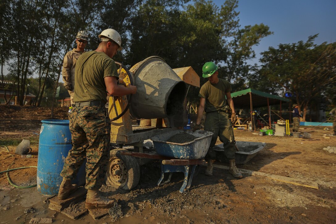 U.S. Marines with Marine Wing Support Squadron 171, pour concrete into a wheel barrel during the building of a multi-purpose room for the Banchamkho school during exercise Cobra Gold 2016 in Rayong, Kingdom of Thailand, Jan. 30, 2016. Cobra Gold 2016, in its 35th iteration, includes a specific focus on Humanitarian Civic Action, community engagement, and medical activities conducted during the exercise to support the needs and humanitarian interests of civilian populations around the region. 