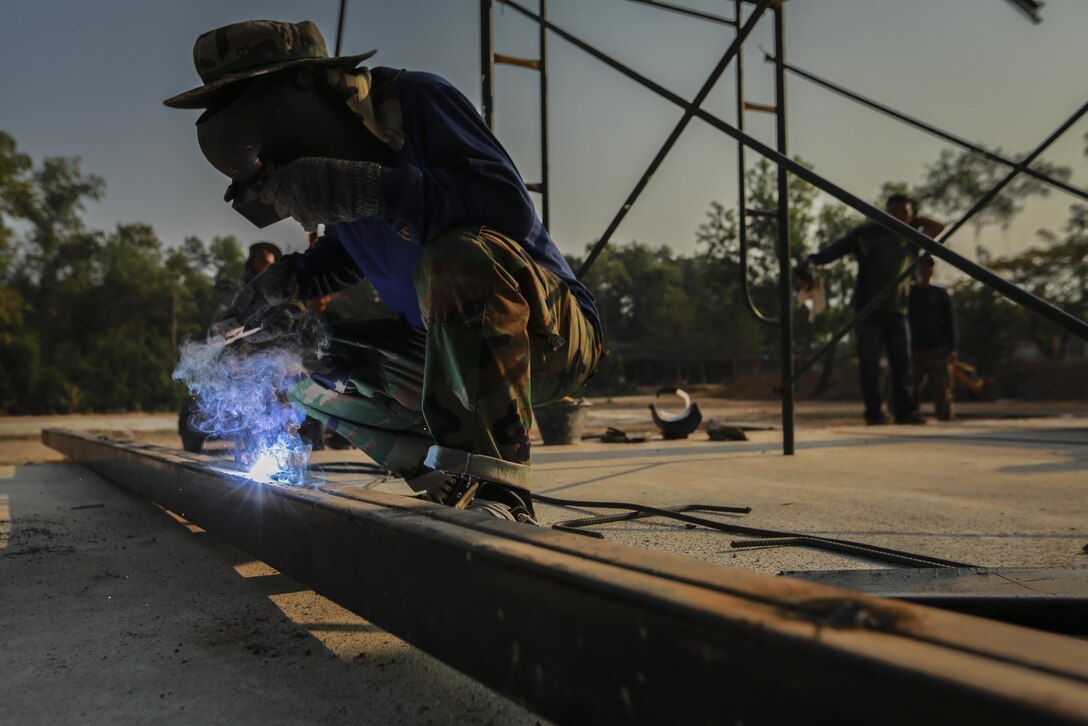 Royal Thai Navy Seaman Manut Puckhago welds a support beam during the building of a multi-purpose room for the Banchamkho school during exercise Cobra Gold 2016 in Rayong, Kingdom of Thailand, Jan. 30, 2016. Cobra Gold 2016, in its 35th iteration, includes a specific focus on Humanitarian Civic Action, community engagement, and medical activities conducted during the exercise to support the needs and humanitarian interests of civilian populations around the region.
