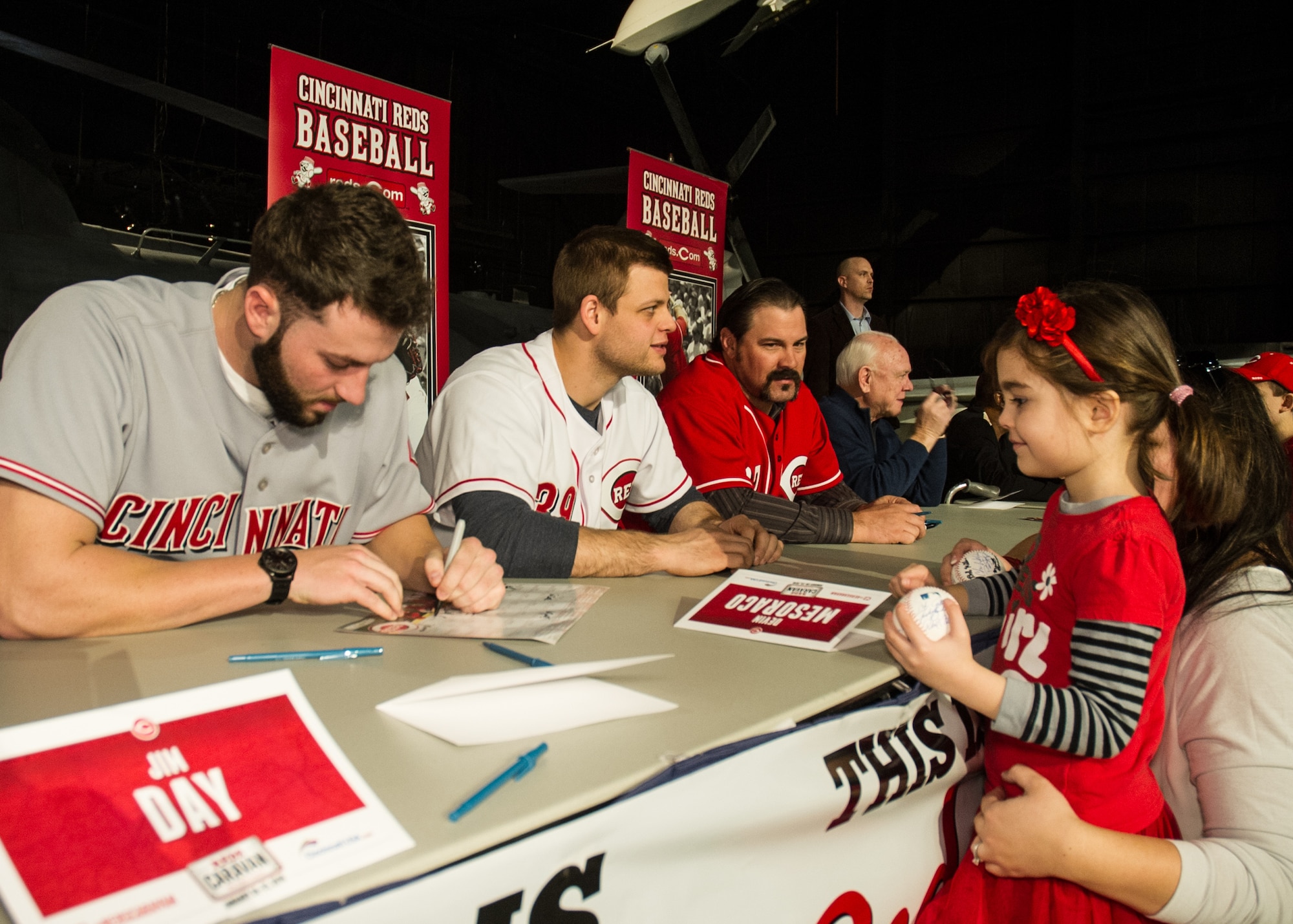 National Museum of the U.S. Air Force visitors had the opportunity to meet members of the Cincinnati Reds organization on January 30th, 2016. Here minor league pitcher Cody Reed signs his autograph for a fan. Also pictured are catcher Devin Mesoraco, former catcher Corky Miller, and president of baseball operations Walt Jocketty. (U.S. Air Force photo)