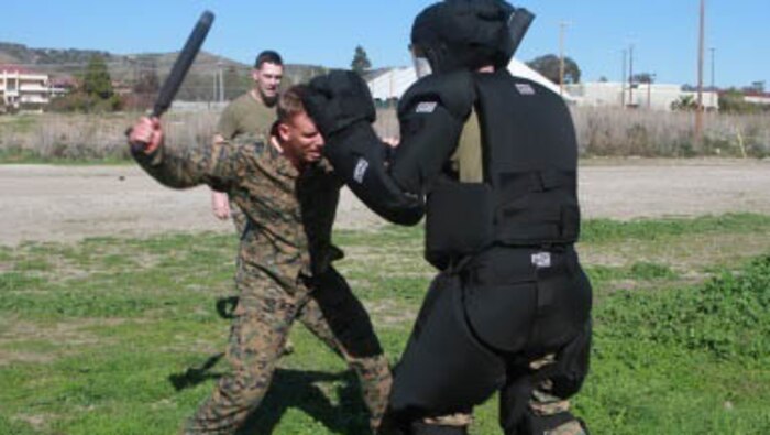 After being blinded with oleoresin capsicum (OC) spray, a Marine runs through an obstacle course performing various strikes with a baton on a target at Marine Corps Base Camp Pendleton, California, Jan. 26, 2016. The Marine is preparing for an upcoming deployment with Company B, 1st Combat Engineer Battalion, 1st Marine Division, I Marine Expeditionary Force. 