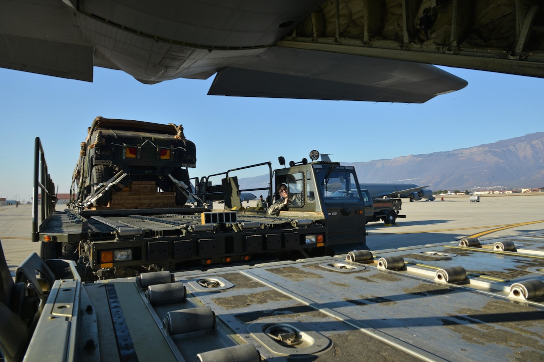 Service members load two parachute-rigged Humvees onto a U.S. Air Force C-130 Hercules aircraft on Aviano Air Base, Italy, Jan. 21, 2016. The Humvees belong to the U.S. Army’s 173rd Airborne Brigade. Army photo by Paolo Bovo
