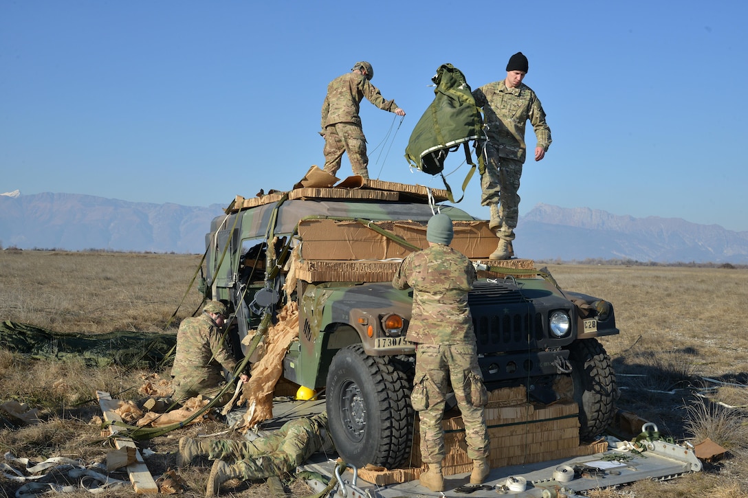 Army paratroopers recover a Humvee after it was dropped onto Frida IV drop zone at Pordenone, Italy, Jan. 21, 2016. The paratroopers are assigned to the 54th Brigade Engineer Battalion, 173rd Airborne Brigade. Army photo by Paolo Bovo