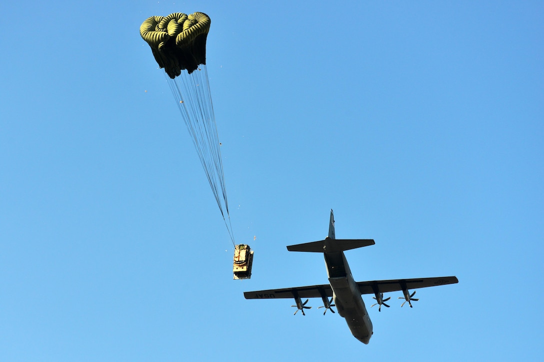 An Air Force C-130 Hercules aircraft drops a Humvee onto Frida IV drop zone in Pordenone, Italy, Jan. 21, 2016. Army photo by Paolo Bovo