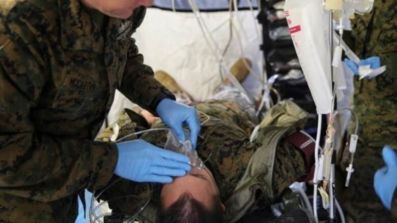 Petty Officer 2nd Class Derek McCarthy, a corpsman with 2nd Medical Battalion, treats a role-player for injuries in preparation for their upcoming multinational exercise, Cold Response 16.1, in Norway.at Marine COrps Base Camp Lejeune, N.C, Jan. 28, 2016.  The corpsmen treated injuries they will encounter in the cold weather climate they will experience in Norway.  