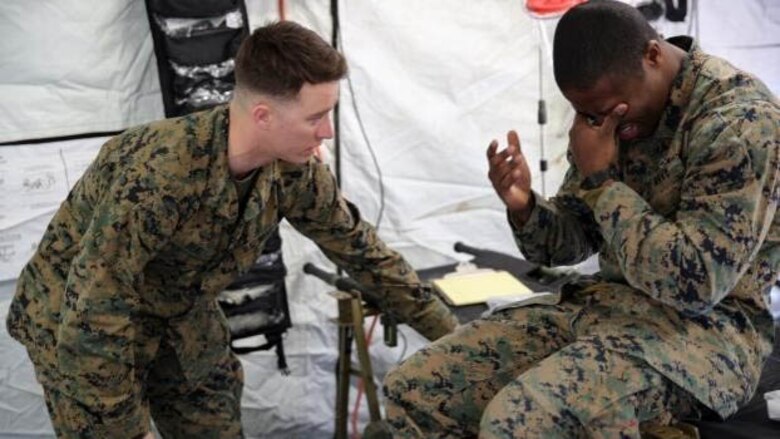Petty Officer 3rd Class Matthew Beal, left, a corpsman with 2nd Medical Battalion, treats a role-player for injuries in preparation for the upcoming multinational exercise, Cold Response 16.1, in Norway, at Marine Corps Base Camp Lejeune, N.C, Jan. 28, 2016.  The corpsmen treated injuries mainly pertaining to the cold weather climate they will be experiencing in Norway. 