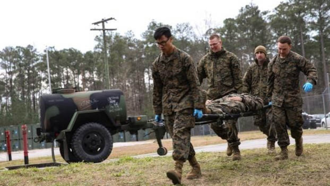 Corpsmen with 2nd Medical Battalion rush role-playing patients into a medical tent at Marine Corps Base Camp Lejeune, N.C, Jan. 28, 2016.  The training is preparing a Shock Trauma Squad to treat cold related injuries for an upcoming multinational exercise, Cold Response 16.1, in Norway.  