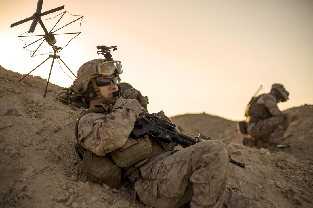 Marine Corps Sgt. Christian Carpenter, foreground, relays commands during a tactical exercise to recover aircraft and personnel at an undisclosed location in Southwest Asia, Jan. 25, 2016. Carpenter is a communications chief assigned to Charlie Company, 1st Battalion, 7th Marine Regiment, Special Purpose Marine Air-Ground Task Force Crisis Response Central Command. Marine Corps photo by Cpl. Akeel Austin