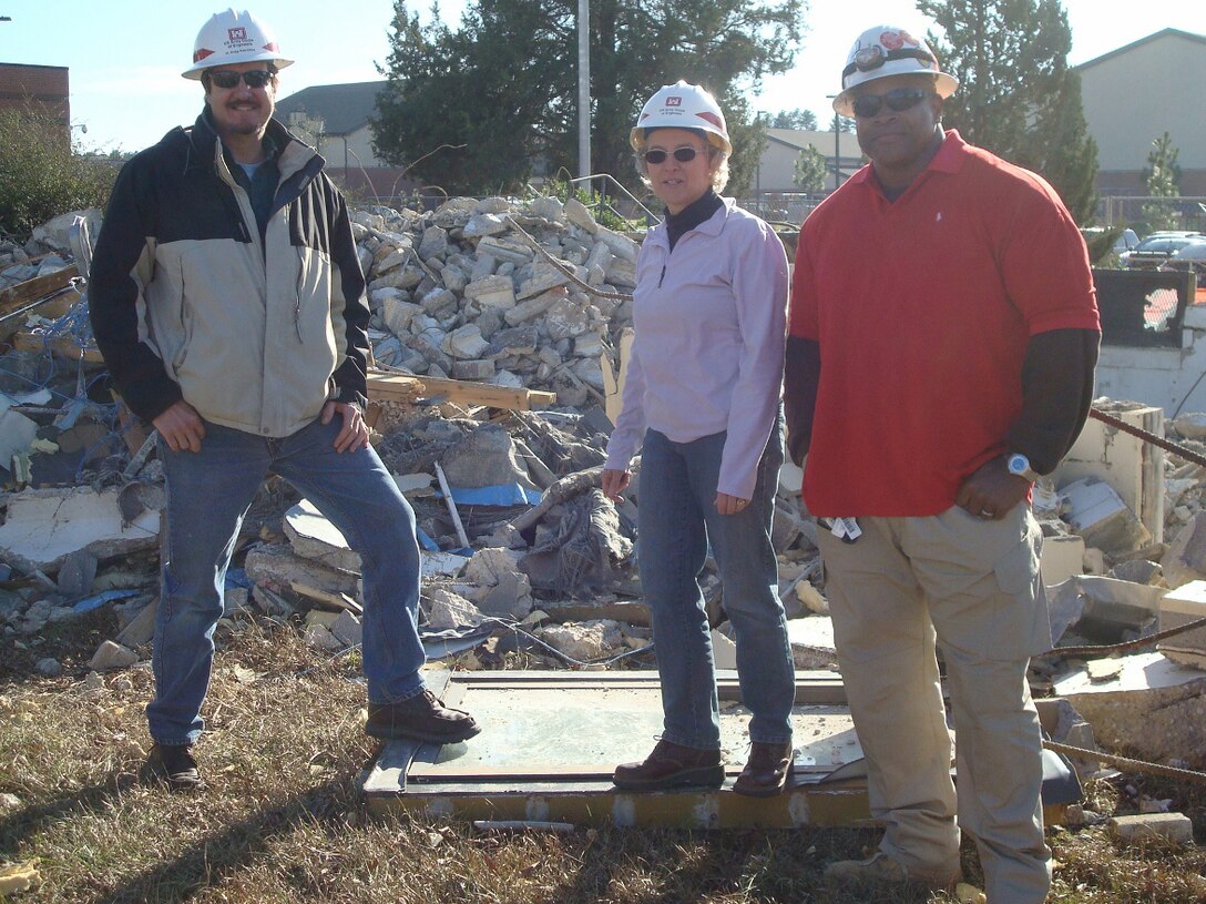 Bryan Smith, a quality assurance representative for the Savannah District, left; Lynn Daniels, Engineering and Support Center, Huntsville virtual project manager; and Amos Persaved, NorthStar employee, conduct demolition work for the Huntsville Center's Facilities Reduction Program at Fort Bragg, North Carolina, Jan. 16. 