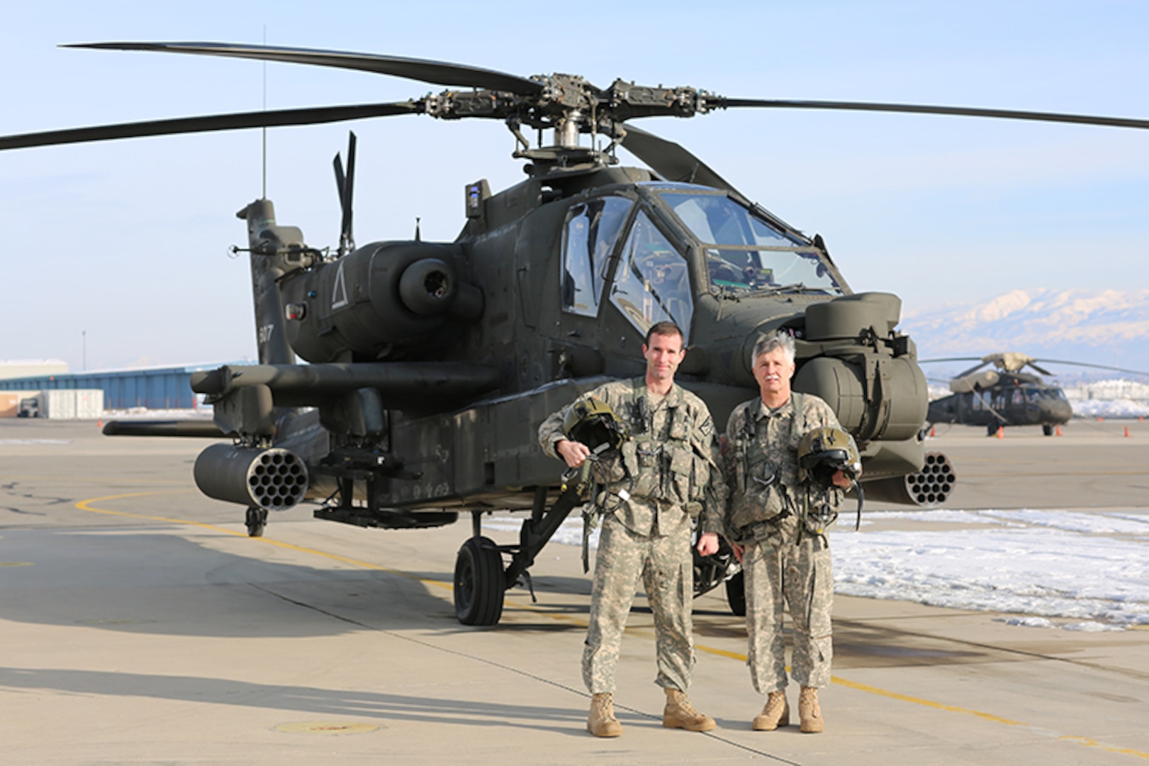 Chief Warrant Officer 5 Ken Jones, world record holder with 10,000 flight hours, has final flight in an AH-64 Apache with his son, Chief Warrant Officer 4 Jared Jones.
 
