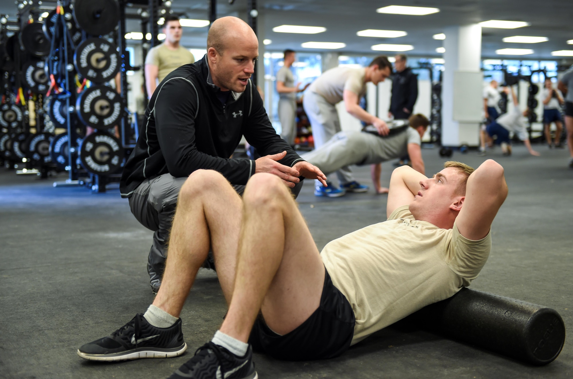 David Koch, an embedded athletic trainer with the 59th Medical Wing’s VIPER Clinic, monitors Airman 1st Class Michael Ferrari, a student with the 342nd Training Squadron, during stretching exercises, Jan. 27, 2016, at the Battle Gym on Joint Base San Antonio-Lackland, Texas. Four athletic trainers are working with students at the 342nd and 343rd Training Squadrons to determine the effectiveness of embedding athletic trainers into military physical training programs. If successful, the initiative could potentially reshape how injured trainees receive care. (U.S. Air Force photo/Staff Sgt. Michael Ellis)
