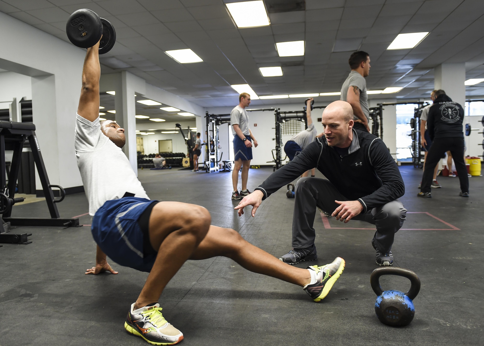 David Koch, an embedded athletic trainer with the 59th Medical Wing’s VIPER Clinic, teaches Senior Airman Christopher Rodriguez, a student from the 342nd Training Squadron, proper lifting techniques, Jan. 27, 2016, at the Battle Gym on Joint Base San Antonio-Lackland, Texas. Four athletic trainers are working with students at the 342nd and 343rd Training Squadrons to determine the effectiveness of embedding athletic trainers into military physical training programs. If successful, the initiative could potentially reshape how injured trainees receive care. (U.S. Air Force photo/Staff Sgt. Michael Ellis)