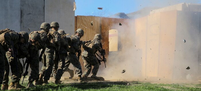 MARINE CORPS BASE CAMP PENDLETON, Calif. – Marines rush in to clear a structure after breaching an entryway with an explosive charge during an urban leaders course, Jan. 29, 2016. During the course, Marines learned four different types of charges used to make a safe entrance into an objective. This type of training allows Marines to practice for possible scenarios when they are deployed to combat zones anywhere on the globe. An instructor with 1st Combat Engineer Battalion, 1st Marine Division, taught this portion of the course to infantrymen of 1st MarDiv. (U.S. Marine Corps photo by Pvt. Robert Bliss)
