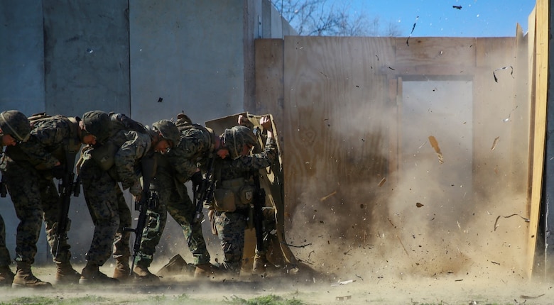 MARINE CORPS BASE CAMP PENDLETON, Calif. – Marines shield themselves from a detonated explosive charge during an urban leaders course, Jan. 29, 2016. During the course, Marines learned four different types of charges used to make a safe entrance into an objective. This type of training allows Marines to practice for possible scenarios when they are deployed to combat zones anywhere on the globe. An instructor with 1st Combat Engineer Battalion, 1st Marine Division, taught this portion of the course to infantrymen of 1st MarDiv. (U.S. Marine Corps photo by Pvt. Robert Bliss)