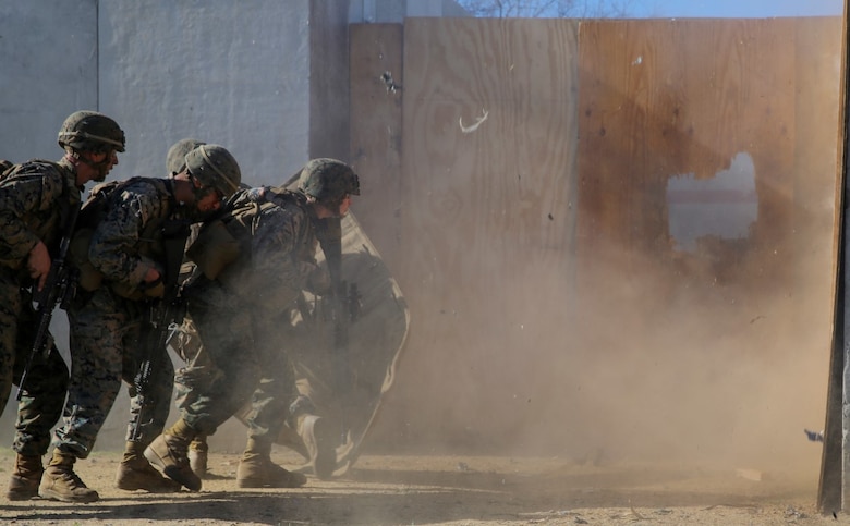 MARINE CORPS BASE CAMP PENDLETON, Calif. – Marines rush in to clear a structure after breaching an entryway with an explosive charge during an urban leaders course, Jan. 29, 2016. During the course, Marines learned four different types of charges used to make a safe entrance into an objective. This type of training allows Marines to practice for possible scenarios when they are deployed to combat zones anywhere on the globe. An instructor with 1st Combat Engineer Battalion, 1st Marine Division, taught this portion of the course to infantrymen of 1st MarDiv. (U.S. Marine Corps photo by Pvt. Robert Bliss)