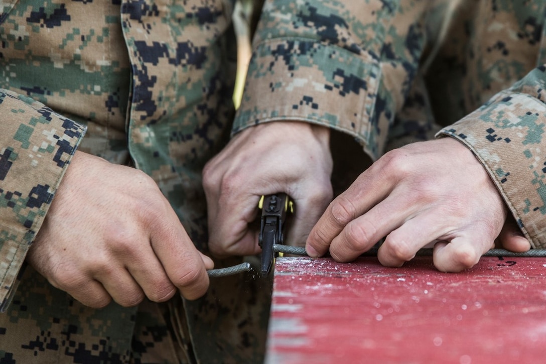 MARINE CORPS BASE CAMP PENDLETON, Calif. – Marines cut detonation cord used to build an explosive charge for breaching an objective during an urban leaders course, Jan. 29, 2016. During the course, Marines learned four different types of charges used to make a safe entrance into an objective. This type of training allows Marines to practice for possible scenarios when they are deployed to combat zones anywhere on the globe. An instructor with 1st Combat Engineer Battalion, 1st Marine Division, taught this portion of the course to infantrymen of 1st MarDiv. (U.S. Marine Corps photo by Sgt. Emmanuel Ramos)