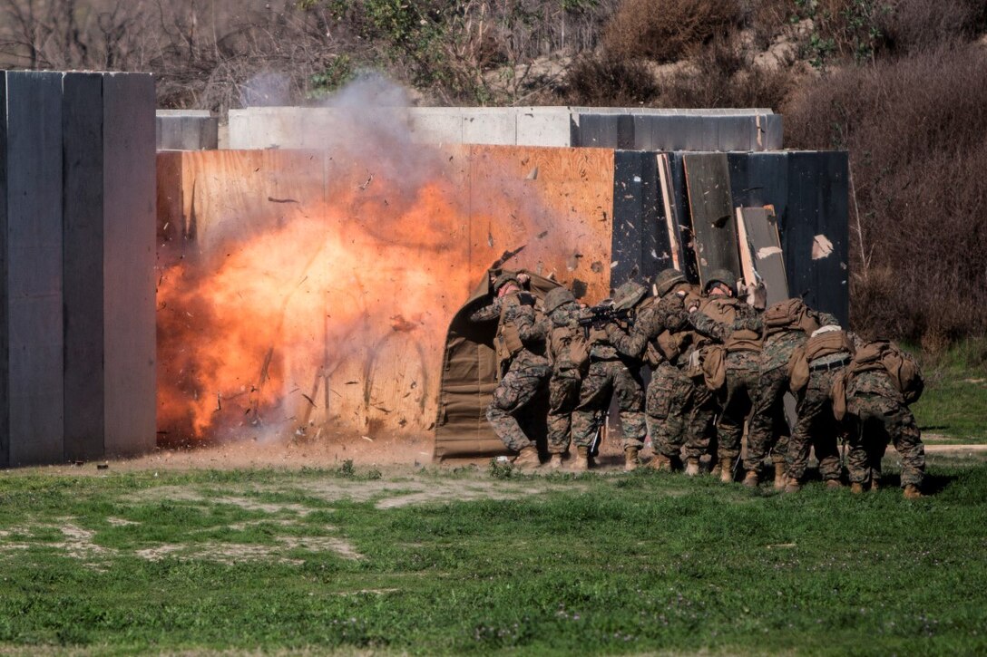 MARINE CORPS BASE CAMP PENDLETON, Calif. – Marines shield themselves from a detonated explosive charge during an urban leaders course, Jan. 29, 2016. During the course, Marines learned four different types of charges used to make a safe entrance into an objective. This type of training allows Marines to practice for possible scenarios when they are deployed to combat zones anywhere on the globe. An instructor with 1st Combat Engineer Battalion, 1st Marine Division, taught this portion of the course to infantrymen of 1st MarDiv. (U.S. Marine Corps photo by Sgt. Emmanuel Ramos)