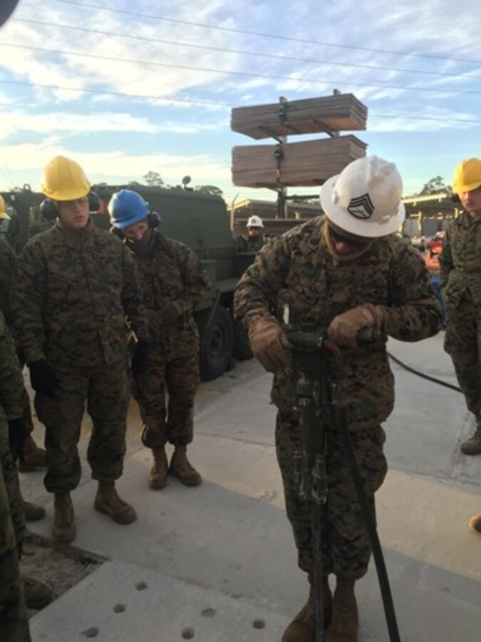 Marines attached to the Basic Combat Engineer course 10-16 (BCE 10-16) at Marine Corps Engineer School, Camp Lejeune, N.C.  watch as SSgt Anwar Hayes, an instructor with Combat Engineer Instruction Company; demonstrates the capabilities and how to use the 260 CFM air compressor.
