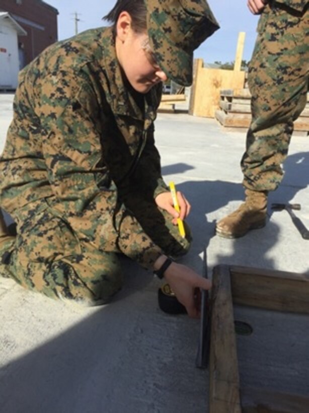 On January 26, 2016 Second Lieutenant Abigail Nagel, a Marine attached to Combat Engineer Officer course 3-16 (CEO 3-16) at Marine Corps Engineer School Camp Lejeune, N.C., measures out the header of a wall as part of a construction practical application. The header is the horizontal member located over the tops of the buildings and provides extra support to the structure. 
