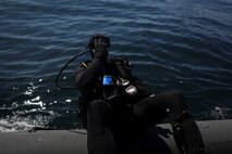 Captain Scott Williams, company commander of Company A, 1st Reconnaissance Battalion, 1st Marine Division, dives out of a rigid-hulled inflatable boat to conduct underwater search operations training, Jan. 28, 2016. The Marines and Sailors of Co. A will use their dive ability to give the 11th Marine Expeditionary Unit a valuable underwater search tool when it deploys later this year.