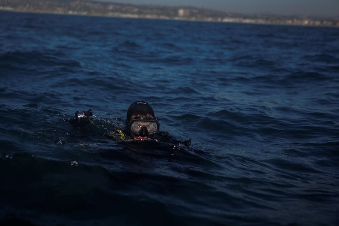 A Marine assigned to Company A, 1st Reconnaissance Battalion, 1st Marine Division, surfaces to board a rigid-hulled inflatable boat after conducting underwater search operations training off the coast of California, Jan. 28, 2016. The Marines and Sailors will use their dive ability to give the 11th Marine Expeditionary Unit a valuable underwater search tool when it deploys later this year.