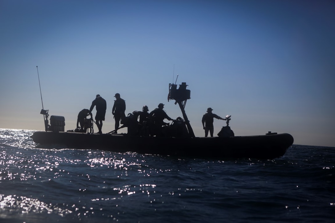 Marines assigned to Company A, 1st Reconnaissance Battalion, 1st Marine Division, and Sailors with Assault Craft Unit One, Naval Beach Group One, wait aboard a rigid-hulled inflatable boat for Marines practicing dive techniques off the coast of California, Jan. 28, 2016. The Marines and Sailors will use their dive ability to give the 11th Marine Expeditionary Unit a valuable underwater search tool when it deploys later this year.