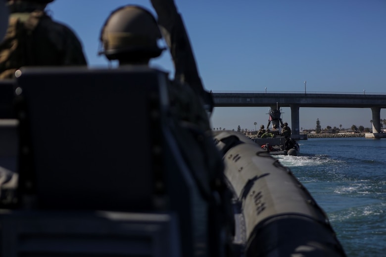 Marines assigned to Company A, 1st Reconnaissance Battalion, 1st Marine Division, and Sailors with Assault Craft Unit One, Naval Beach Group One, maneuver rigid-hulled inflatable boats out of the Dana Landing Marina to conduct dive operations, Jan. 28, 2016. The Marines and Sailors will use their dive ability to give the 11th Marine Expeditionary Unit a valuable underwater search tool when it deploys later this year.