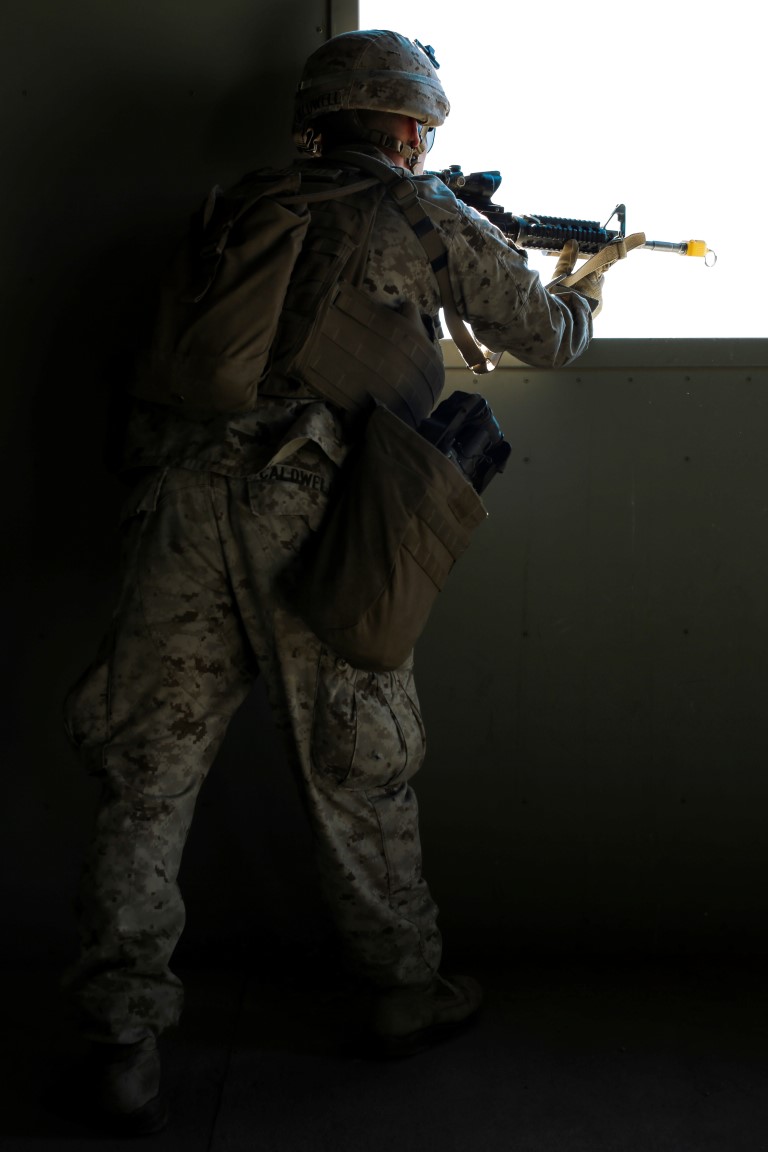 U.S. Marine Corps Lance Cpl. Jacob Caldwell, a rifleman with 3rd Battalion, 3rd Marine Regiment, 3rd Marine Division, provides security through a window during a simulated urban terrain assault during Integrated Training Exercise 2-16 at Marine Corps Air Ground Combat Center Twentynine Palms, Calif., Jan. 26, 2016. The training was conducted to strengthen unit coordination and maneuvers during urban terrain assaults. (U.S. Marine Corps photo by Cpl. Trever A. Statz/Released)