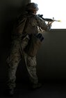 U.S. Marine Corps Lance Cpl. Jacob Caldwell, a rifleman with 3rd Battalion, 3rd Marine Regiment, 3rd Marine Division, provides security through a window during a simulated urban terrain assault during Integrated Training Exercise 2-16 at Marine Corps Air Ground Combat Center Twentynine Palms, Calif., Jan. 26, 2016. The training was conducted to strengthen unit coordination and maneuvers during urban terrain assaults. (U.S. Marine Corps photo by Cpl. Trever A. Statz/Released)