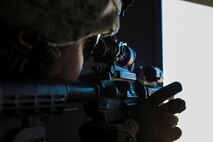 U.S. Marine Corps Lance Cpl. Skylar Carbrough, a combat engineer with 3rd Battalion, 3rd Marine Regiment, 3rd Marine Division, provides security through a window during a simulated urban terrain assault during Integrated Training Exercise 2-16 at Marine Corps Air Ground Combat Center Twentynine Palms, Calif., Jan. 26, 2016. The training was conducted to strengthen unit coordination and maneuvers during urban terrain assaults. (U.S. Marine Corps photo by Cpl. Trever A. Statz/Released)