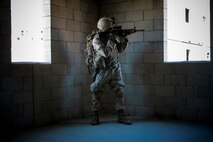 U.S. Marine Corps Lance Cpl. Skylar Carbrough, a combat engineer with 3rd Battalion, 3rd Marine Regiment, 3rd Marine Division, provides security through a window during a simulated urban terrain assault during Integrated Training Exercise 2-16 at Marine Corps Air Ground Combat Center Twentynine Palms, Calif., Jan. 26, 2016. The training was conducted to strengthen unit coordination and maneuvers during urban terrain assaults. (U.S. Marine Corps photo by Cpl. Trever A. Statz/Released)