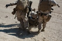 U.S. Marines and a Navy Corpsman with 3rd Battalion, 3rd Marine Regiment, 3rd Marine Division, perform a simulated casualty evacuation during an urban terrain assault during Integrated Training Exercise 2-16 at Marine Corps Air Ground Combat Center Twentynine Palms, Calif., Jan. 26, 2016. The training was conducted to strengthen unit coordination and maneuvers during urban terrain assaults. (U.S. Marine Corps photo by Cpl. Trever A. Statz/Released)