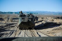 U.S. Marines with 3rd Battalion, 3rd Marine Regiment, 3rd Marine Division, move into an offensive position in amphibious assault vehicles to conduct a simulated urban assault during Integrated Training Exercise 2-16 at Marine Corps Air Ground Combat Center Twentynine Palms, Calif., Jan. 26, 2016. The training was conducted to strengthen unit coordination and maneuvers during urban terrain assaults. (U.S. Marine Corps photo by Cpl. Trever A. Statz/Released)
