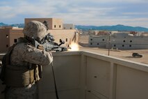 U.S. Marine Corps Pfc. Andre Henry, a machine gunner with Lima Company, 3rd Battalion, 3rd Marine Regiment, 3rd Marine Division, shoots at a simulated enemy vehicle during urban defensive training during Integrated Training Exercise 2-16 at Marine Corps Air Ground Combat Center Twentynine Palms, Calif., Jan. 29, 2016. The training was conducted to strengthen unit coordination and maneuvers during urban terrain assaults. (U.S. Marine Corps photo by Cpl. Trever A. Statz/Released)