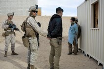 U.S. Marines with 3rd Battalion, 3rd Marine Regiment, 3rd Marine Division, search residents during urban defensive training during Integrated Training Exercise 2-16 at Marine Corps Air Ground Combat Center Twentynine Palms, Calif., Jan. 29, 2016. The training was conducted to strengthen unit coordination and maneuvers during urban terrain assaults. (U.S. Marine Corps photo by Cpl. Trever A. Statz/Released)