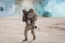 U.S. Marines with 3rd Battalion, 3rd Marine Regiment, 3rd Marine Division, conduct a simulated casualty evacuation during urban defensive training during Integrated Training Exercise 2-16 at Marine Corps Air Ground Combat Center Twentynine Palms, Calif., Jan. 29, 2016. The training was conducted to strengthen unit coordination and maneuvers during urban terrain assaults. (U.S. Marine Corps photo by Cpl. Trever A. Statz/Released)