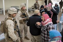 U.S. Marines with 3rd Battalion, 3rd Marine Regiment, 3rd Marine Division, talk to simulated residents during urban defensive training during Integrated Training Exercise 2-16 at Marine Corps Air Ground Combat Center Twentynine Palms, Calif., Jan. 29, 2016. The training was conducted to strengthen unit coordination and maneuvers during urban terrain assaults. (U.S. Marine Corps photo by Cpl. Trever A. Statz/Released)