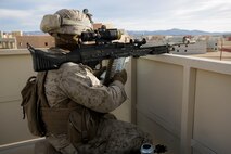 U.S. Marine Corps Lance Cpl. Harold Stalworth, a rifleman with 3rd Battalion, 3rd Marine Regiment, 3rd Marine Division, provides security on a rooftop during urban defensive training during Integrated Training Exercise 2-16 at Marine Corps Air Ground Combat Center Twentynine Palms, Calif., Jan. 29, 2016. The training was conducted to strengthen unit coordination and maneuvers during urban terrain assaults. (U.S. Marine Corps photo by Cpl. Trever A. Statz/Released)