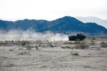U.S. Marines with 2nd Battalion, 7th Marine Regiment, 1st Marine Division, move into position in an amphibious assault vehicle during a motorized assault course during Integrated Training Exercise 2-16 at Marine Corps Air Ground Combat Center Twentynine Palms, Calif., Jan. 28, 2016. The training was one of a series of evolutions that will take place during ITX 2-16, a Marine Air Ground Task Force sized training event led by the 5th Marine Regiment, which will forward deploy later this year with various elements to create the Special Purpose Marine Air Ground Task Force Crisis Response Central Command 16.2. (U.S. Marine Corps photo by Cpl. Trever A. Statz/Released)