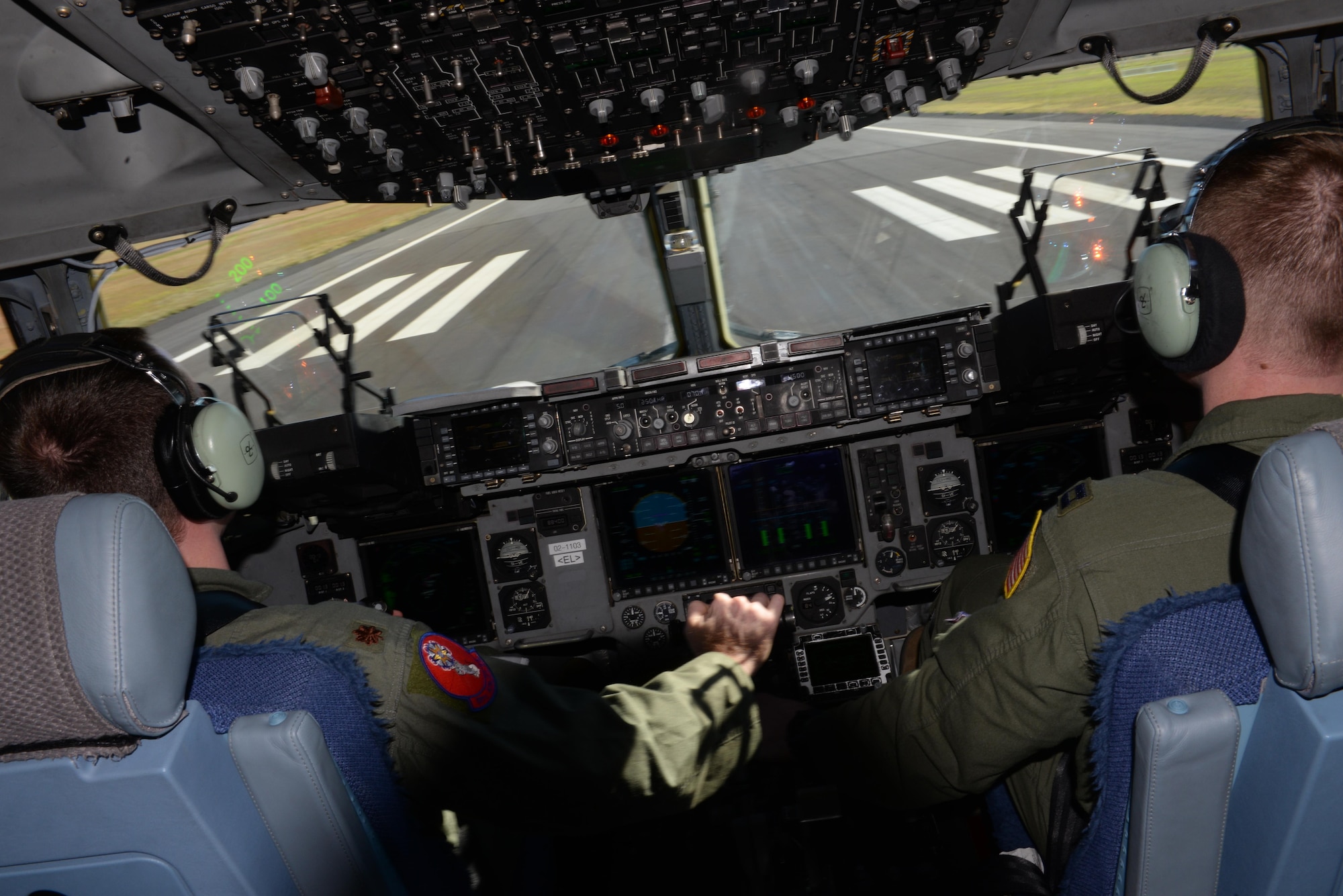 U.S. Air Force Maj. David Tomlinson, 58th Airlift Squadron evaluation pilot and U.S. Air Force Capt. Patrick O’neil, 58th AS instructor pilot, approach a landing strip in a U.S. Air Force C-17 Globemaster III cargo aircraft at Ilopango International Airport, San Salvador in El Savador, Jan. 30, during the 2016 Ilopango Airshow. The C-17 was sent from Altus Air Force Base, Okla., to foster relationships between the U.S. and El Salvador. The aircraft was setup as a static display for the attendees to view and learn about some of its capabilities. (U.S. Air Force photo by Senior Airman Franklin R. Ramos/Released)