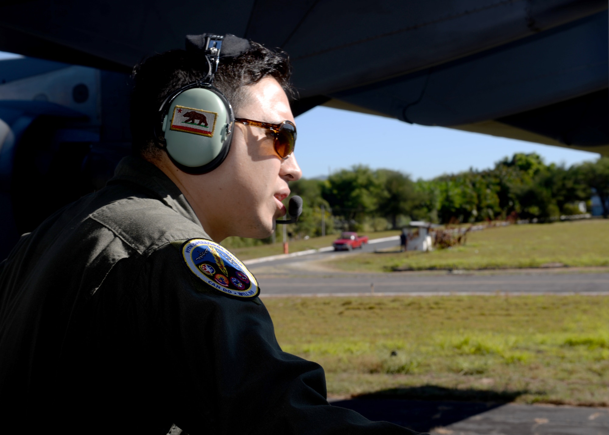 U.S. Air Force Tech Sgt. Trinidad Gutierrez, 97th Operations Group instructor loadmaster, guides a U.S. Air Force C-17 Globemaster III cargo aircraft, while it reverses on a runway at Ilopango International Airport in San Salvador, El Savador, Jan. 30, during the 2016 Ilopango Airshow. The C-17 was sent from Altus Air Force Base, Okla., to foster relationships between the U.S. and El Salvador. The aircraft was setup as a static display for the attendees to view and learn about some of its capabilities. (U.S. Air Force photo by Senior Airman Franklin R. Ramos/Released)