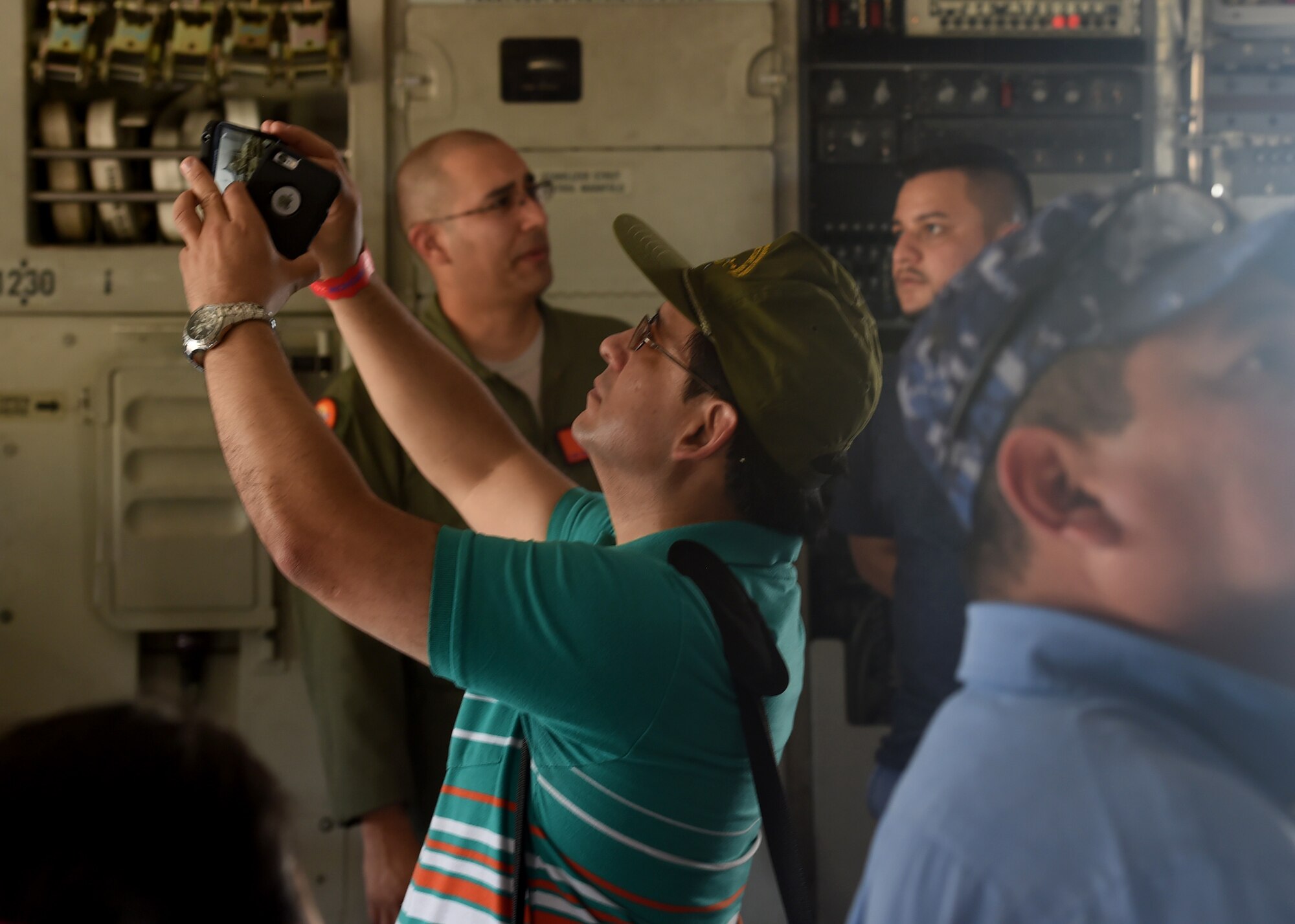 A citizen from El Salvador, takes a photo inside a U.S. Air Force C-17 Globemaster III cargo aircraft, 58th Airlift Squadron, at Ilopango International Airport in San Salvador, El Savador, Jan. 30, during the 2016 Ilopango Airshow. The C-17 was sent from Altus Air Force Base, Okla., to foster relationships between the U.S. and El Salvador. The aircraft was setup as a static display for the attendees to view and learn about some of its capabilities. (U.S. Air Force photo by Senior Airman Franklin R. Ramos/Released)